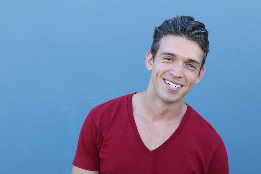 Man smiling outside of Bonita Springs dental office