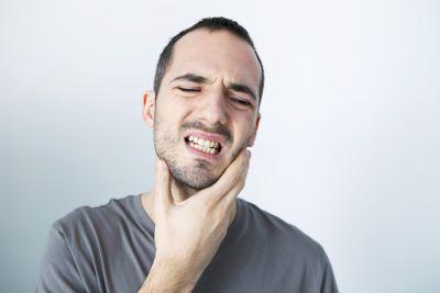 Man with bad tooth pain in need of a root canal in Bonita Springs, FL