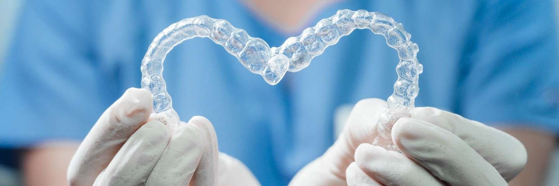Dentist showing clear aligners in a heart shape in Bonita Springs FL 