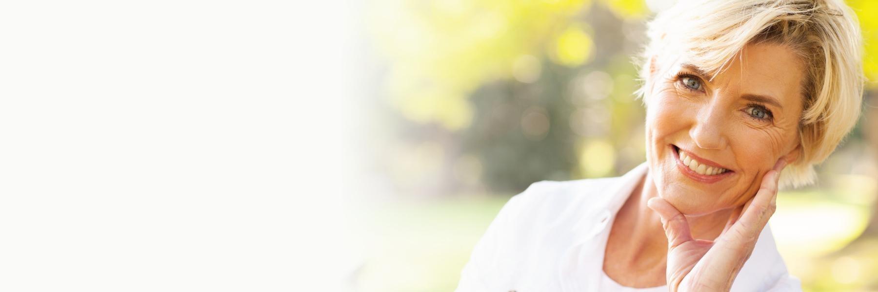 Dental patient smiling outside near Bonita Springs, FL