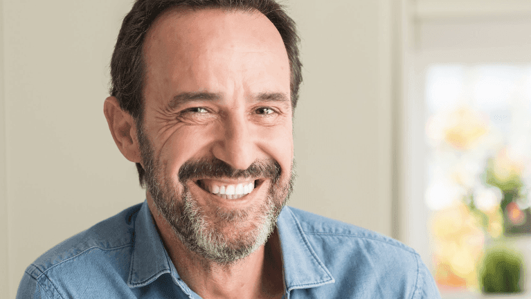 Man in Bonita Springs confidently smiling with his dental implant