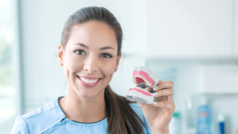 woman holding dentures bonita springs