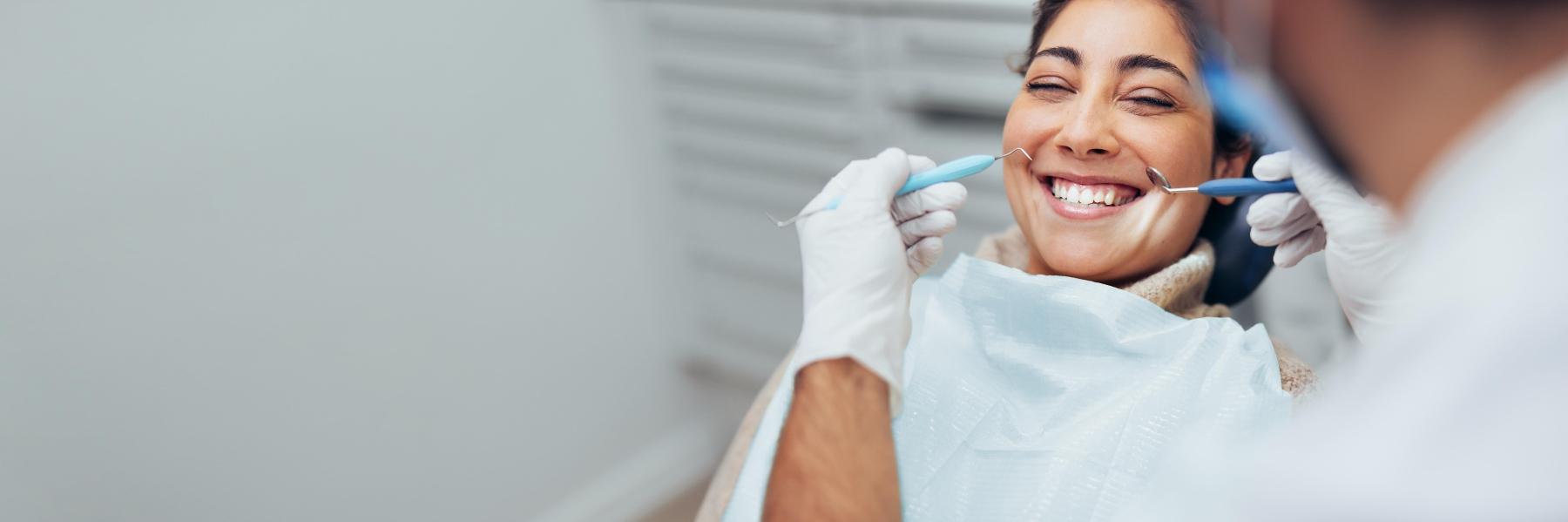 Woman laughing in treatment chair at dentist in Bonita Springs FL