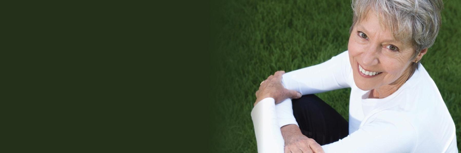 Woman sitting in the grass at Bonita Nature Place in 34135