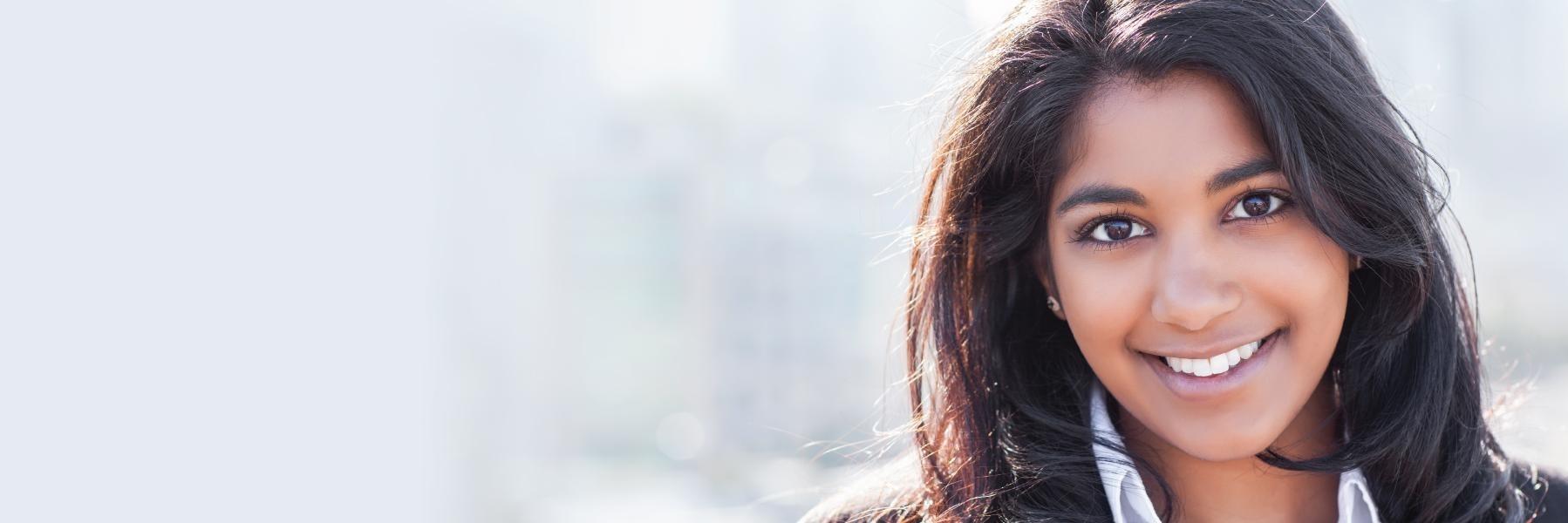 Woman smiling outside of dentist office in North Naples FL