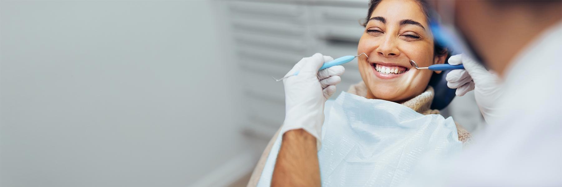 Patient smiling during teeth cleaning at dentist near me 34135
