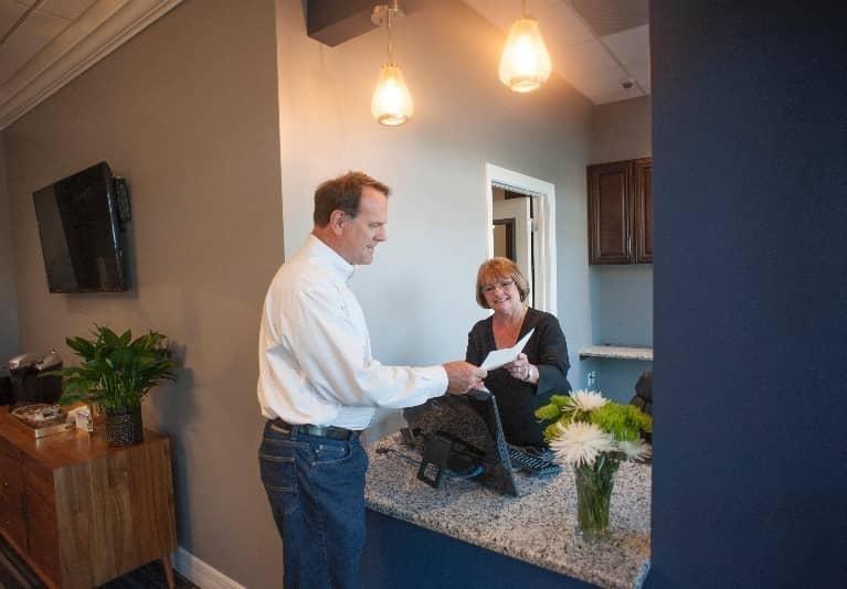 Patient at front desk of Bonita Springs dentist office